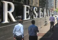 Australian central bank holds rates but keeps hike on table