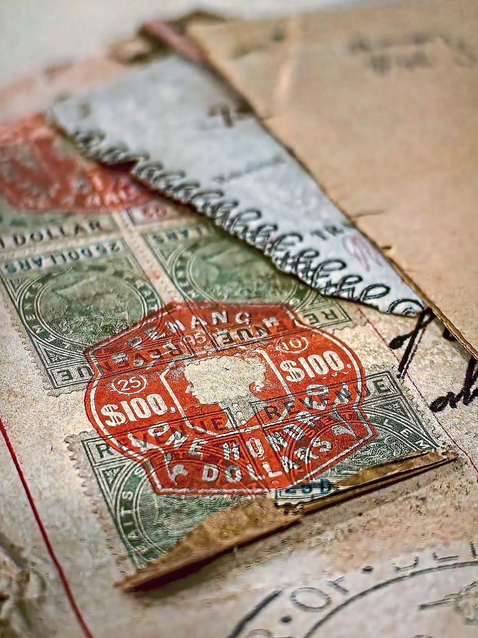 A rare vintage $100 Straits Settlements revenue stamp, featuring the profile of Queen Victoria and stamped in Penang.