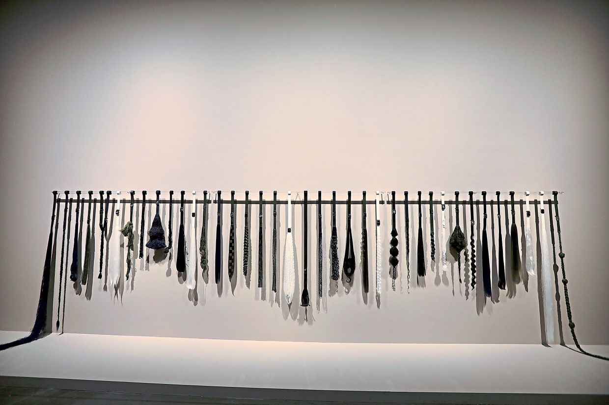 Umar's practice came into focus at the 'Ilham Art Show 2025', where his 'Asuhan Dan Dandanan' series turned familiar canvas school belts into a conceptual exploration of discipline, identity and student life. Photo: The Star/Low Lay Phon 