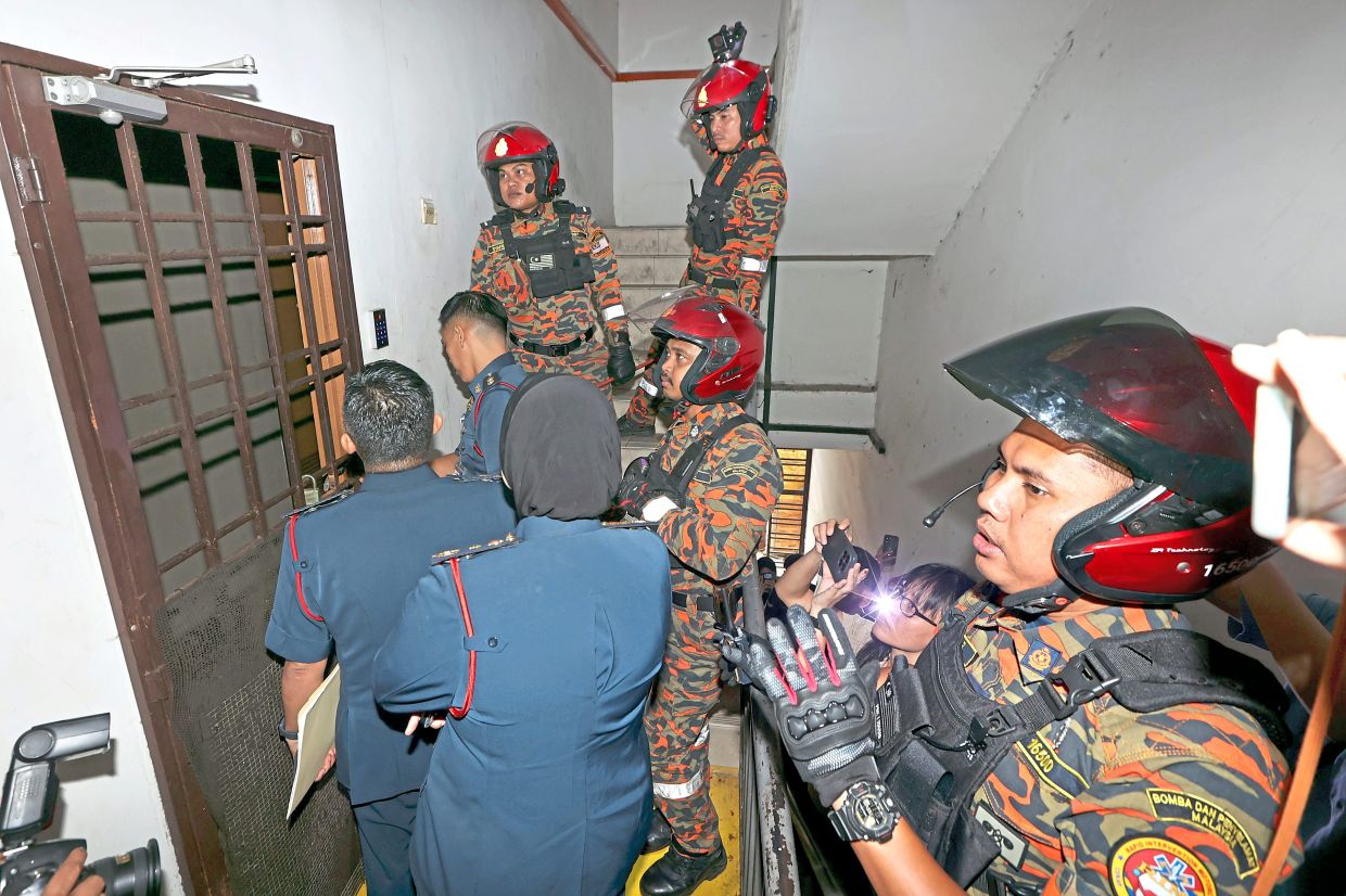 Fire and Rescue Department personnel attempting to enter a suspected bird’s nest hostel in Johor Baru.