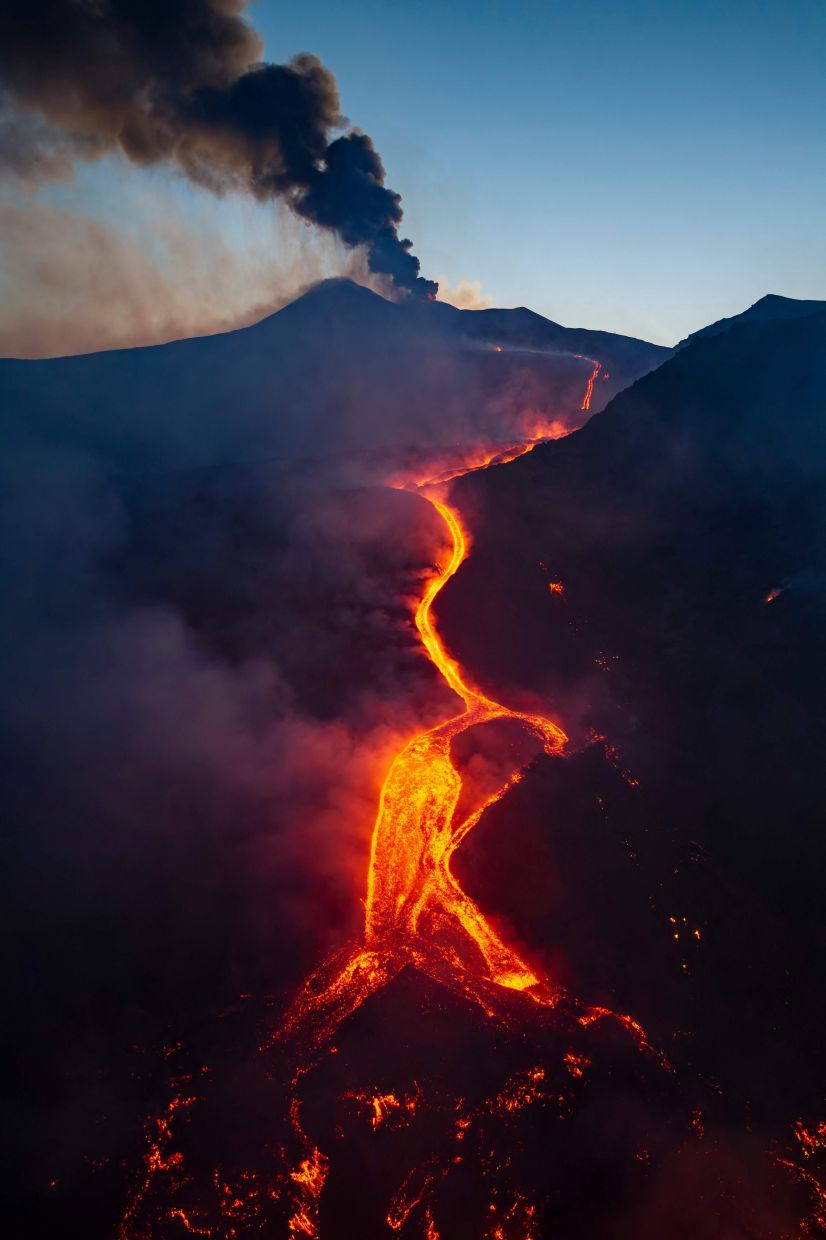 Smoke raising an lava flowing from Mount Etna volcano during an eruption earlier this week. — Etna Walk/AFP