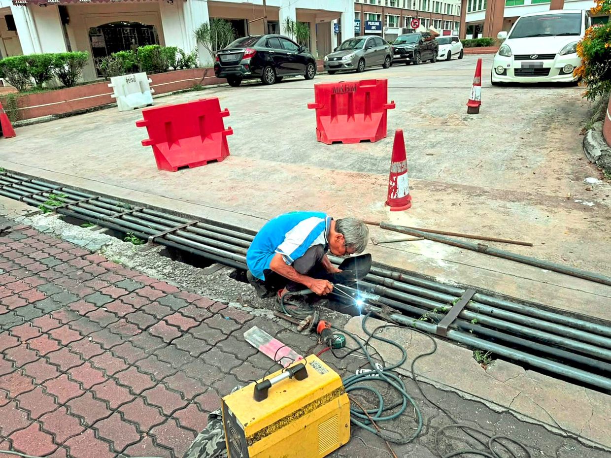 A contractor carrying out temporary repairs at the Greentown Avenue site.