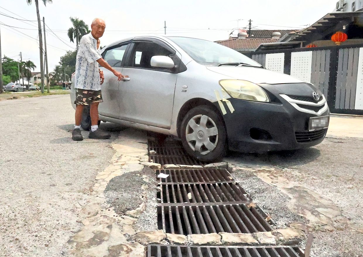 Tan says he had to change his car bumper due to damage from the poor road conditions on Persiaran Cempaka Sari 26.