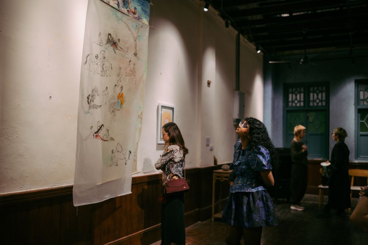 Visitors viewing Carabelle Cheong’s 'Hang Li Po' series titled 'A Garden Before Time' at the 'Garden Symphony' group exhibition. Photo: Jessielyee