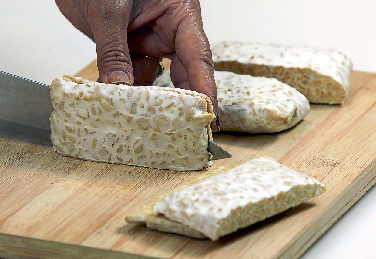 Slice tempeh block into pieces.