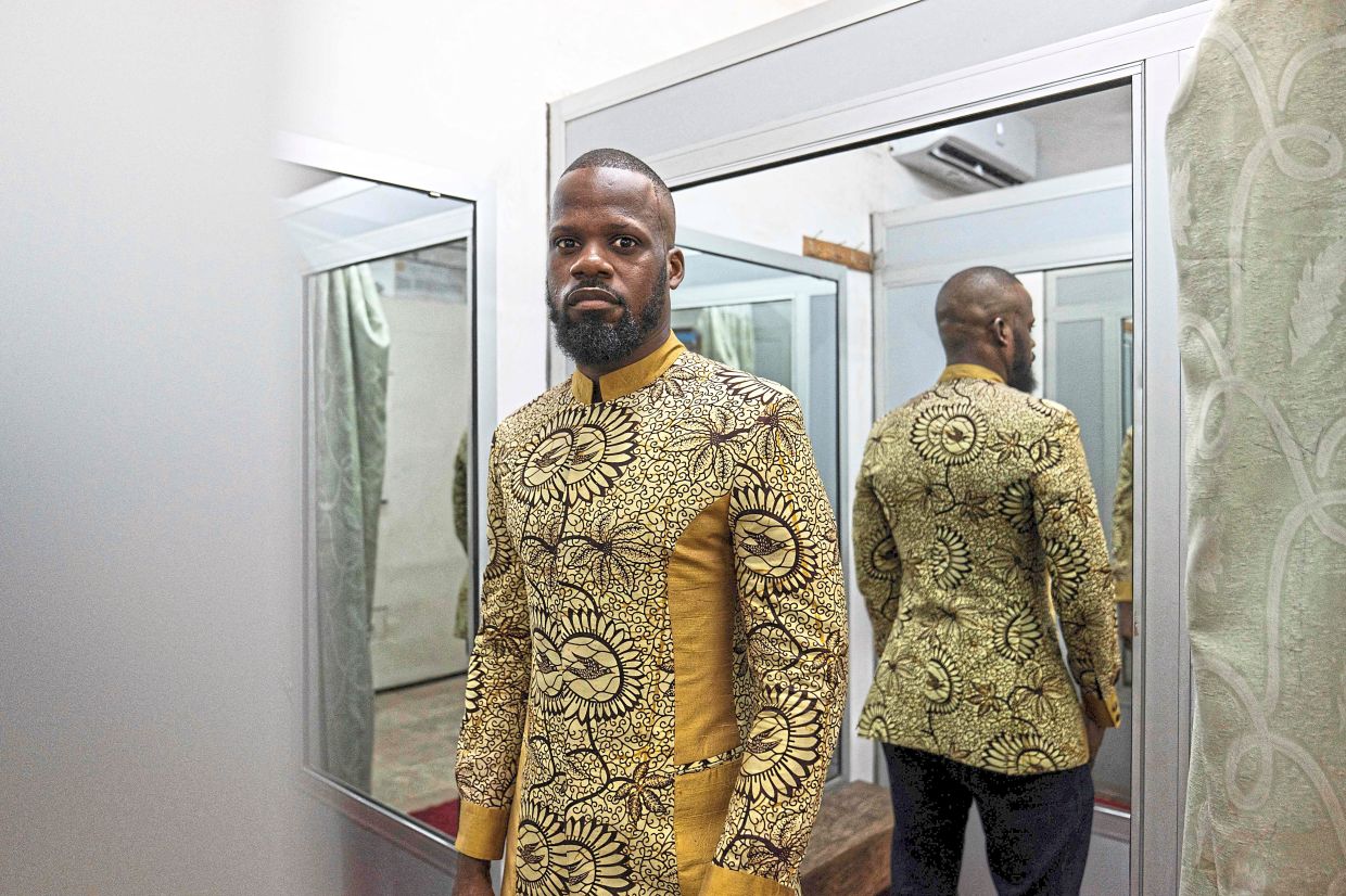 Auguy poses for a photo wearing an abacost in Kinshasa. — AFP
