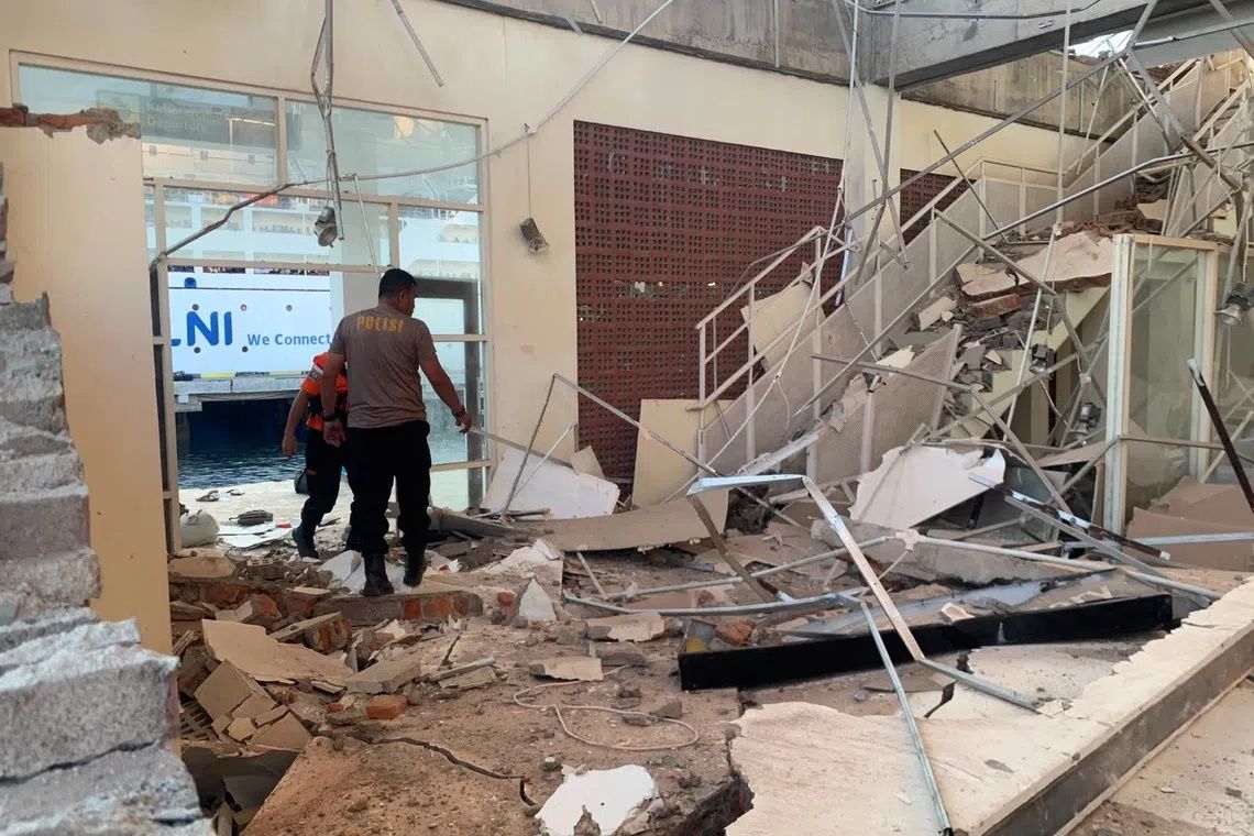 Rescuers inspecting a heavily damaged building at L. Say port, following an earthquake in Sikka, East Nusa Tenggara, on Aug 15. -- PHOTO: REUTERS