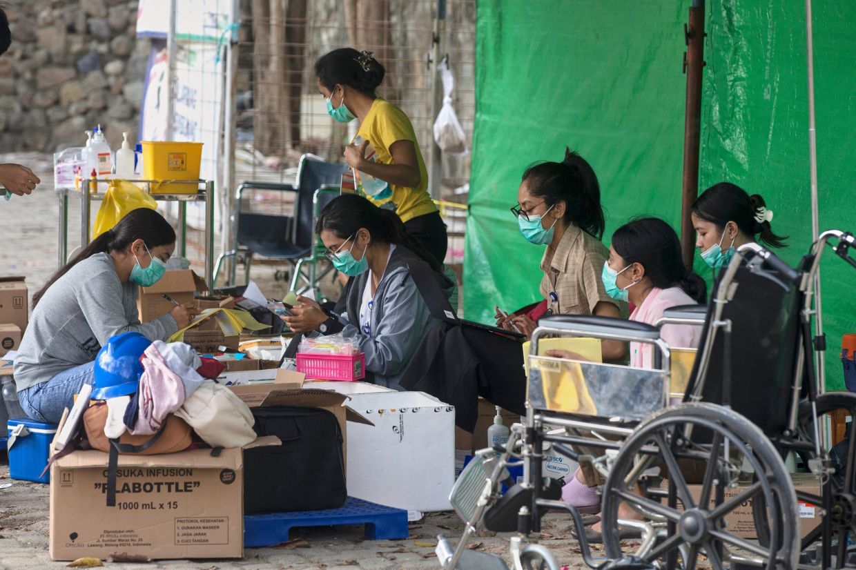 Hospital staff work under a makeshift tent following an earthquake in Labuan Bajo, East Nusa Tenggara province, Indonesia, on Saturday, Aug. 15, 2026. -- AP Photo/Firdia Lisnawati
