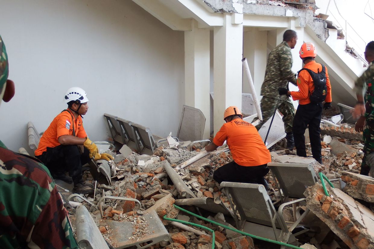 A rescue team searches for victims in the ruins of the Laurensius Say Port in Maumere, Sikka, East Nusa Tenggara, on Saturday, August 15, 2026, after a magnitude 7.7 earthquake struck Flores Island. -- Photo by ARNOLD WELIANTO / AFP
