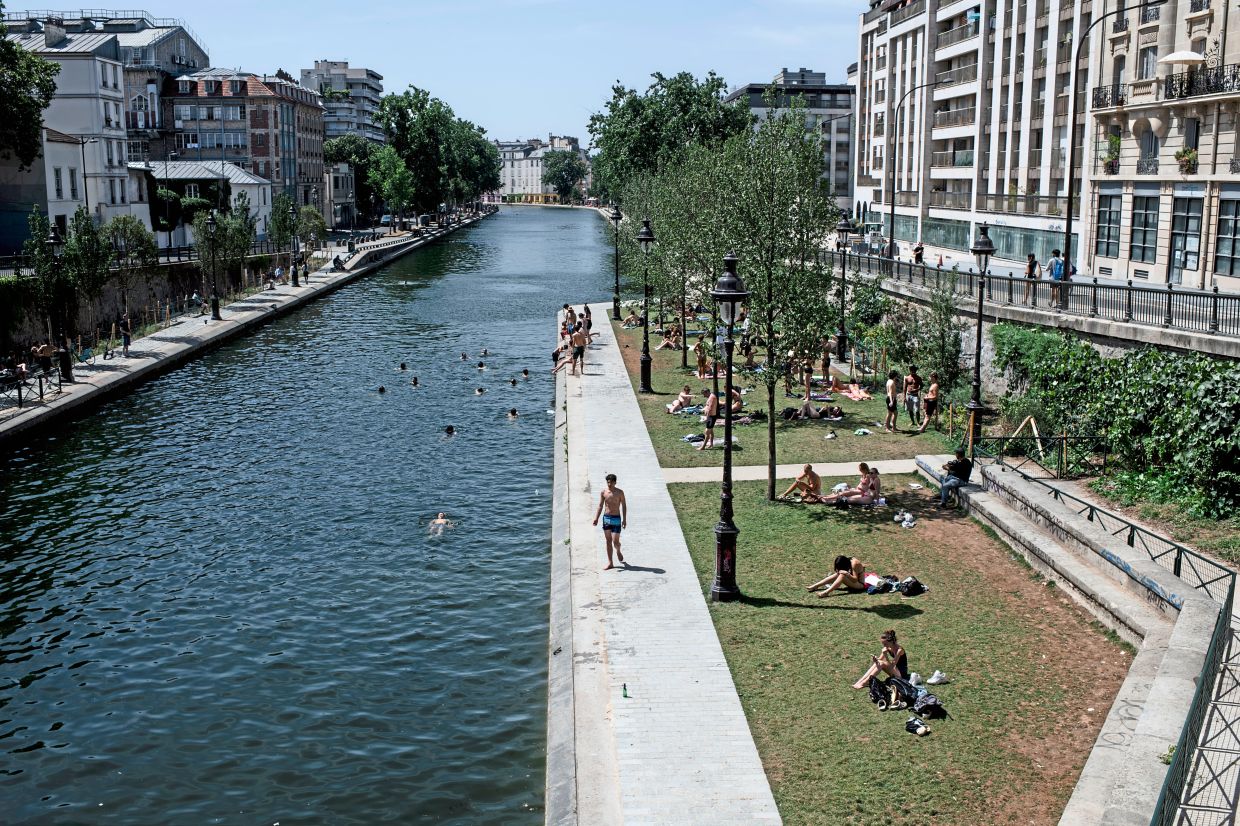 People swimming at Canal Saint-Martin during a heat wave in Paris in June.