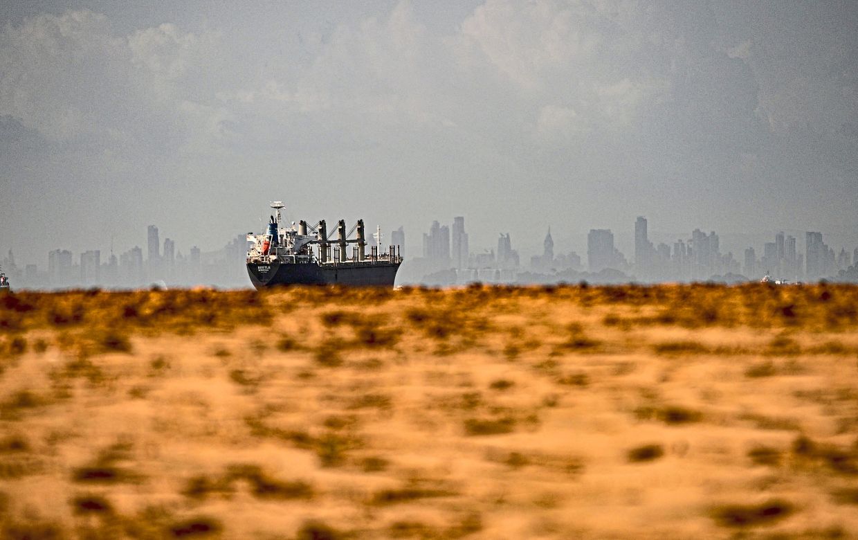 A cargo ship waits before entering the Panama Canal. The dry stretch has raised concerns about operations in the canal. — AFP