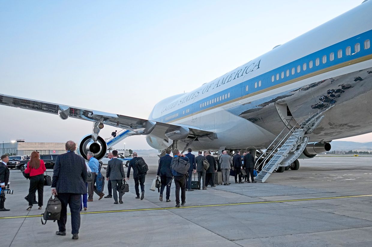 Members of the news media and others board Air Force One in Ankara. — Photos: Doug Mills/The New York Times