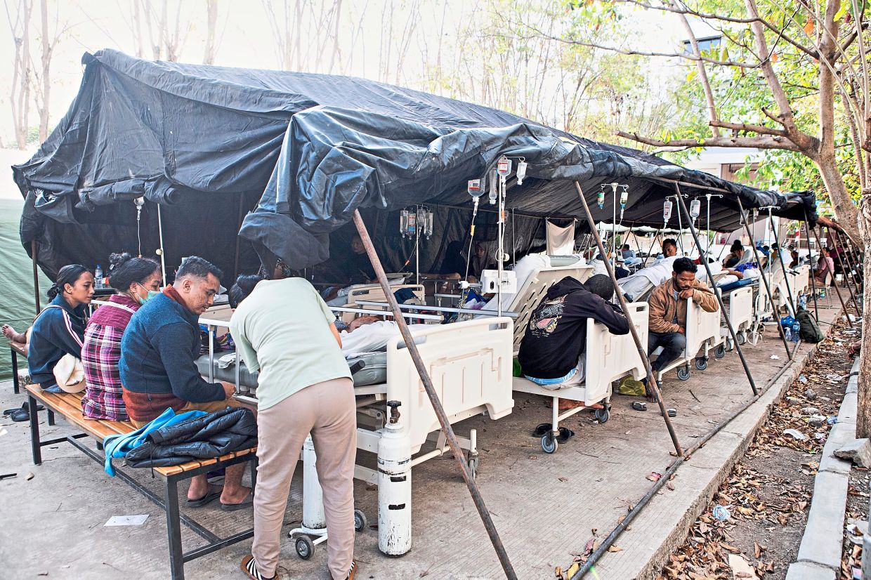 Much-needed medical care: Patients receiving treatment at a makeshift tent outside a hospital following the quake in Labuan Bajo, East Nusa Tenggara province. — AP