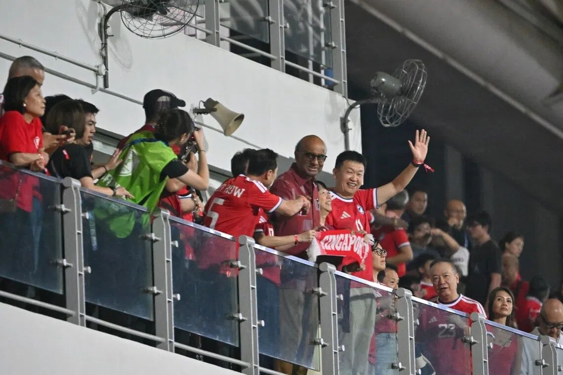 President Tharman Shanmugaratnam and his spouse, Ms Jane Ittogi, with FAS president Forrest Li at Jalan Besar Stadium. -- ST PHOTO: ARIFFIN JAMAR