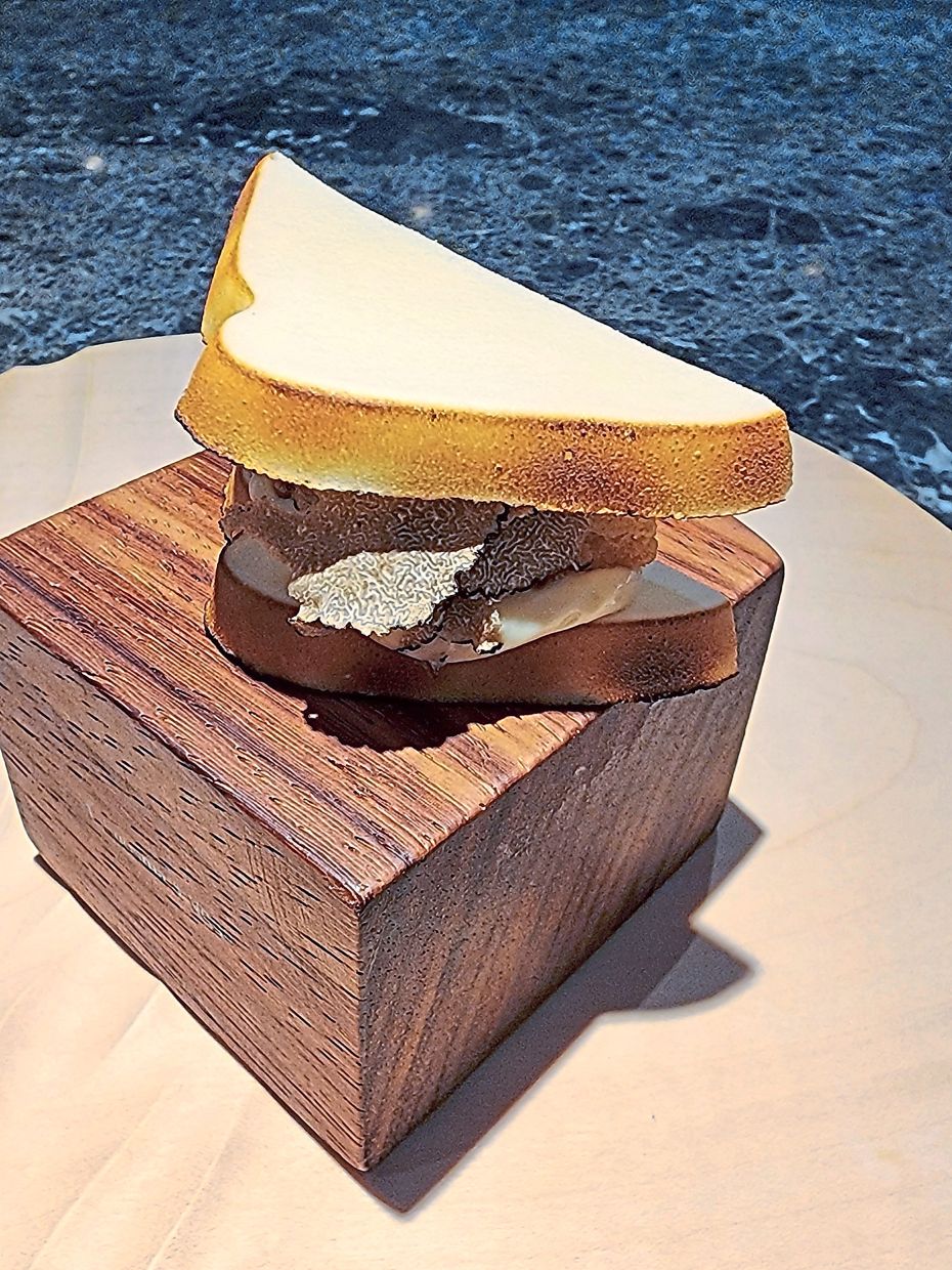 Roti bakar features a meringue-shaped bread stuffed with French Comte cheese, red dates and truffles.
