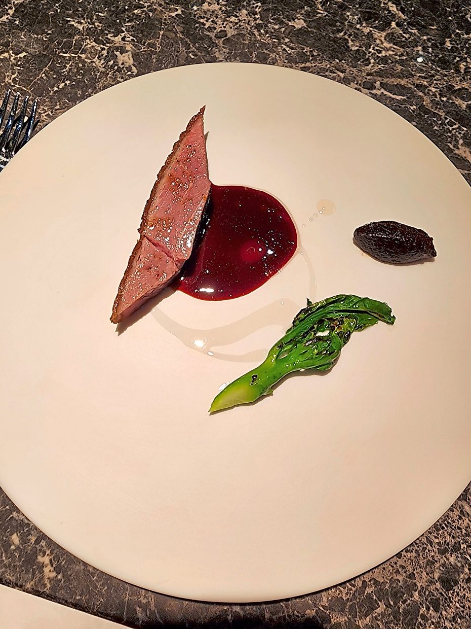 Ng's duck has been cooked to perfection but what is perhaps even more interesting is his black garlic and red currant sauce.