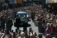 Bonnie Tyler fans line the streets of Welsh village as her coffin is brought home