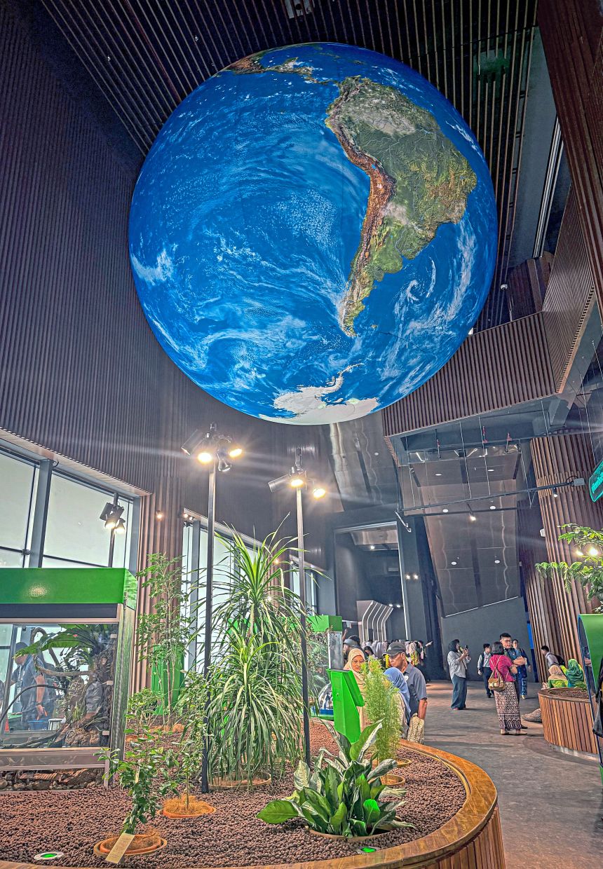 A giant globe hangs above a display of Sarawak’s biodiversity at the centre.
