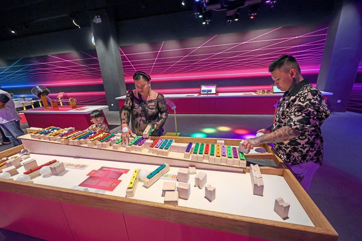 Visitors of all ages enjoying the interactive exhibits at the centre.