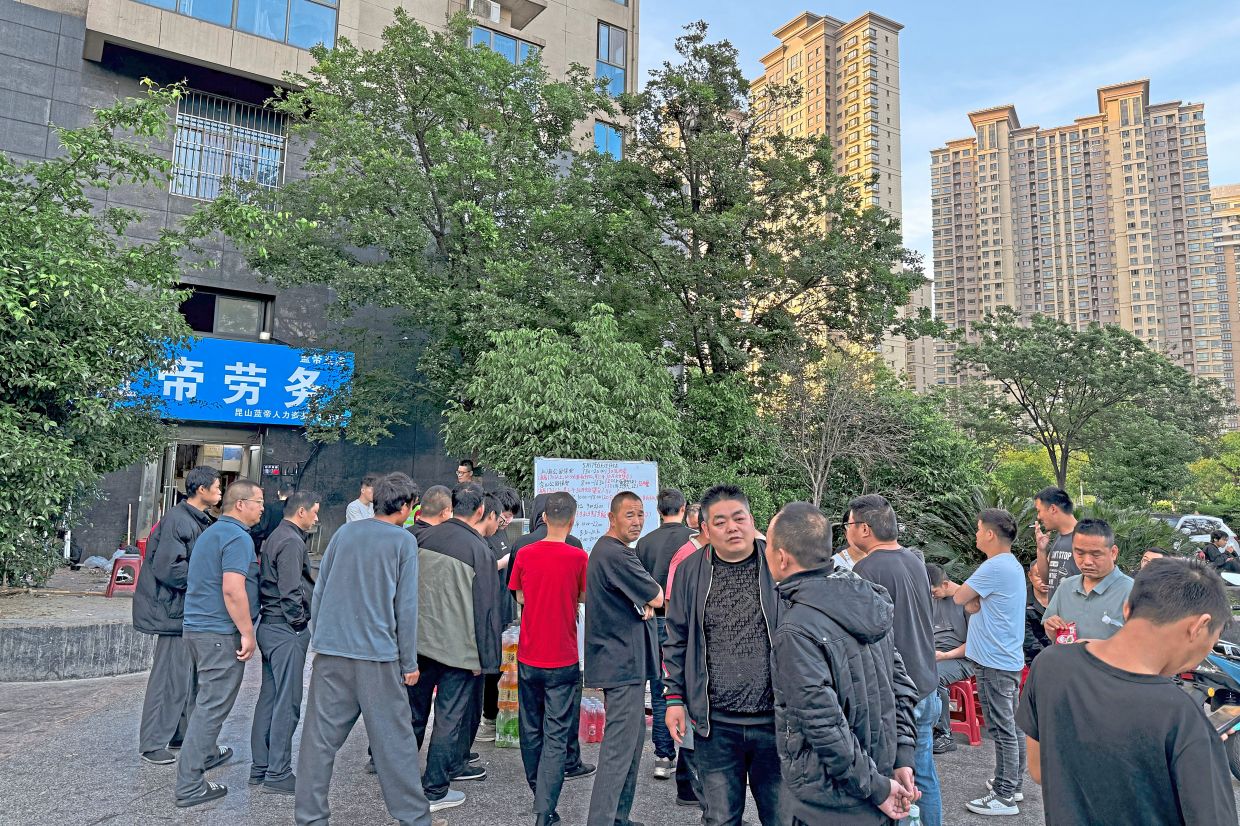 Men looking for daily gigs in Kunshan, the heart of China’s manufacturing industry in May 2026. —Vivian Wang/The New York Times