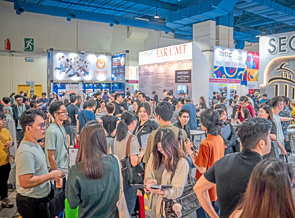 Visitors engaging directly with educational institution representatives and career specialists to discover the right academic paths.