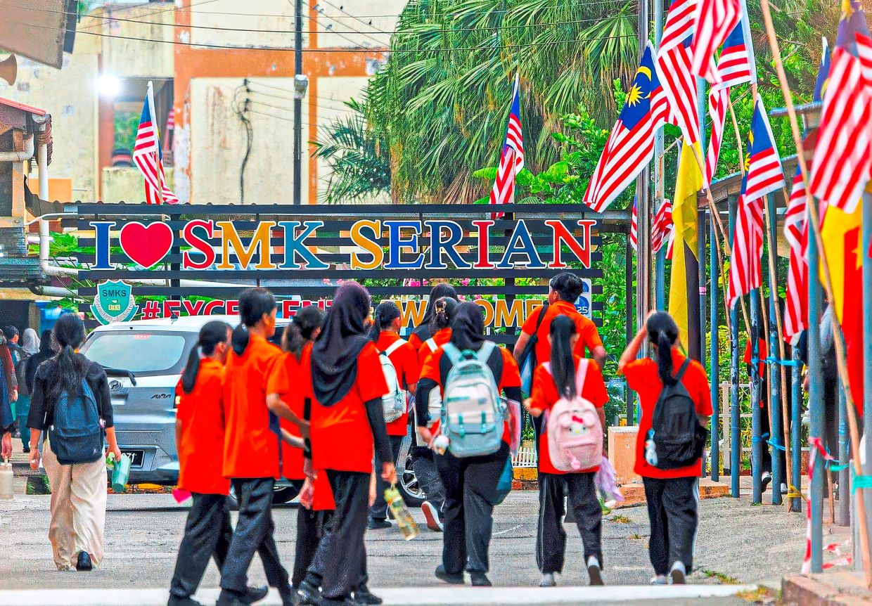 Back to the grind: Students heading to SMK Serian as schools in the division reopened. — ZULAZHAR SHEBLEE / The Star