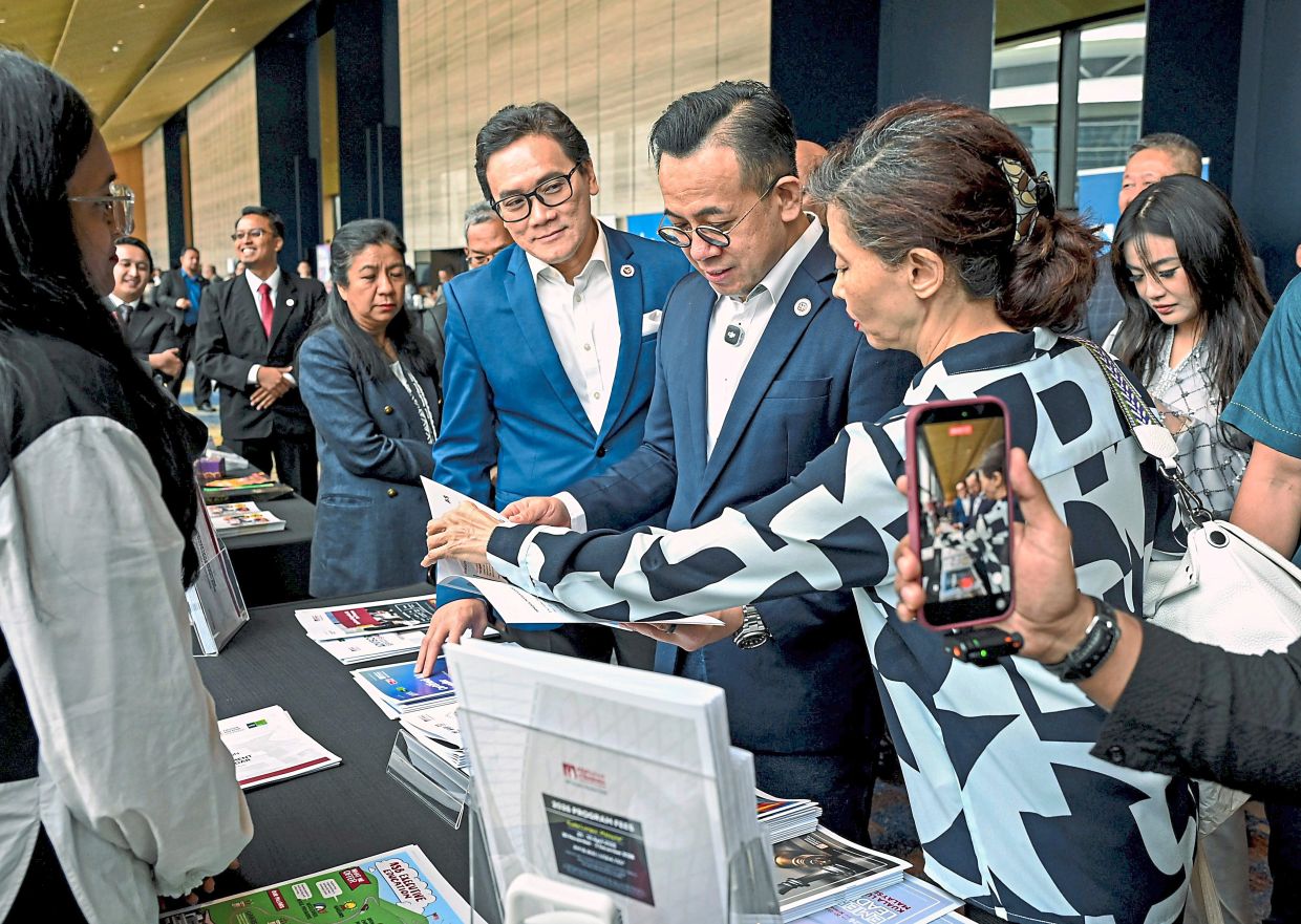 Closer look: Sim (centre) visiting a booth after the inauguration of the BrandQuest Programme 2026 in Kuala Lumpur. — Bernama