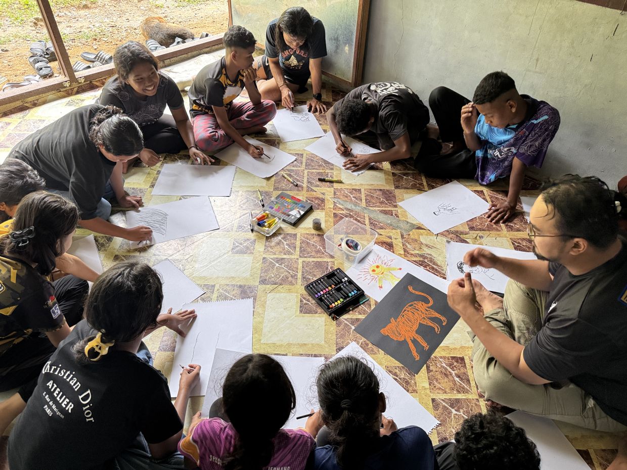 One of the participating artists, Nizar Sulaiman (far right), is also an art teacher, so during their visits to Pos Jernang, he would have drawing sessions with the village children. — Mimpi Jernang