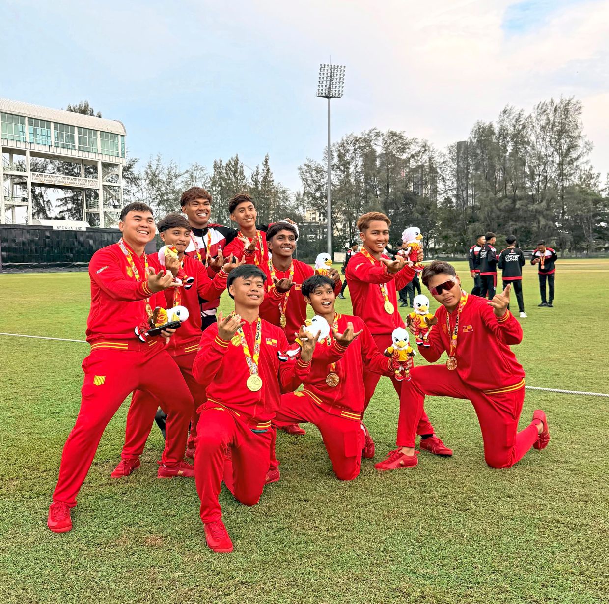 All smiles: The players pose with their medal for a picture.