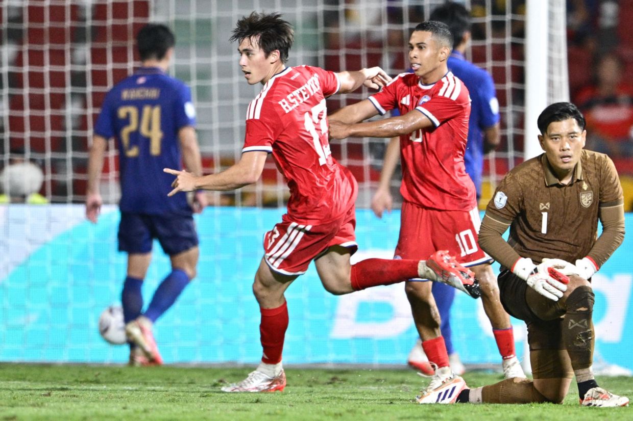 Singapore's Harhys Stewart (centre) celebrates with a teammate after scoring a goal during the second leg of the 2026 Asean Hyundai Cup football semi-final match between Thailand and Singapore at Rajamangala National Stadium in Bangkok on Tuesday, August 18, 2026. -- Photo by ANTHONY WALLACE / AFP