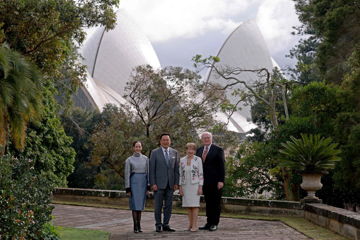 Thailand's Prime Minister Anutin Charnvirakul (second left) stands with his wife Thananon Niramit,, the Governor of New South Wales Margaret Beazley (second right), and her husband Dennis Wilson, as they pose for a photograph in front of the Sydney Opera House during an official function at Government House in Sydney on tuesday, August 18, 2026. The Thai Prime Minister is on a three-day official visit to Australia. -- Photo by DAVID GRAY / AFP