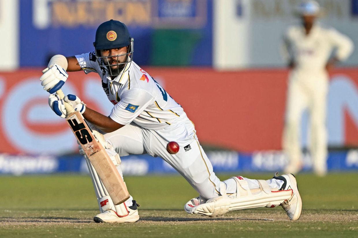 Sri Lanka's Sonal Dinusha plays a shot during the fourth day of the first Test cricket match between Sri Lanka and India at the Galle International Stadium in Galle on Tuesday, August 18, 2026. -- Photo by Ishara S. KODIKARA / AFP