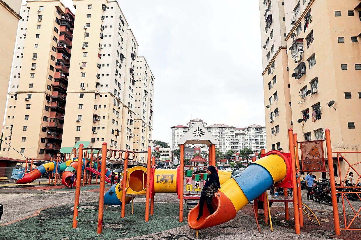 The playground outside Taman Permata Fadason apartments is also used for parking motorcycles.