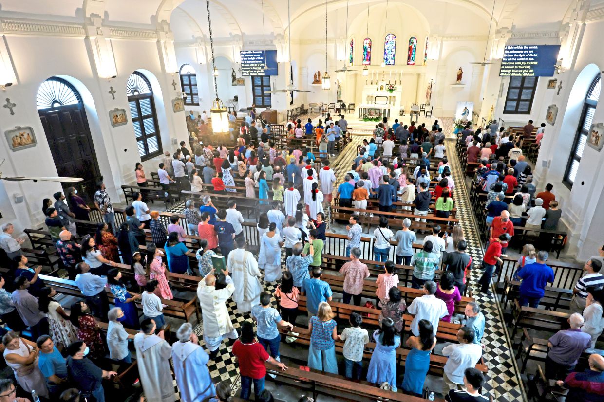 The large congregation filling the Church of the Assump­tion in George Town for the 240th anniversary mass.