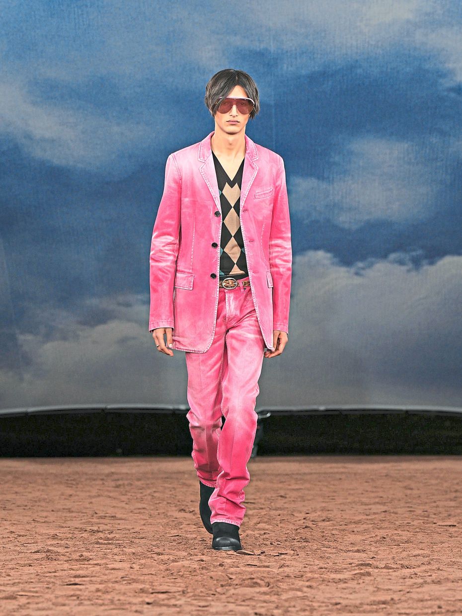 A pink stonewashed denim ensemble paired with a classic V-neck argyle sweater creates a wonderfully stylish and unexpected look. Photo: Burberry