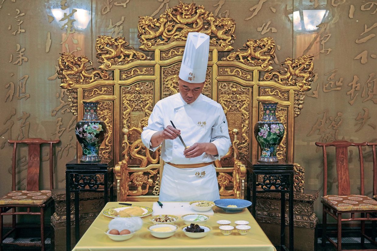 Chef Fan Liangliang demonstrates making a dish at Fangshan Restaurant.