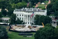 Trump the builder carves his legacy in stone as pressures mount