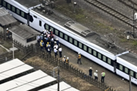Japan train hits station workers, killing four