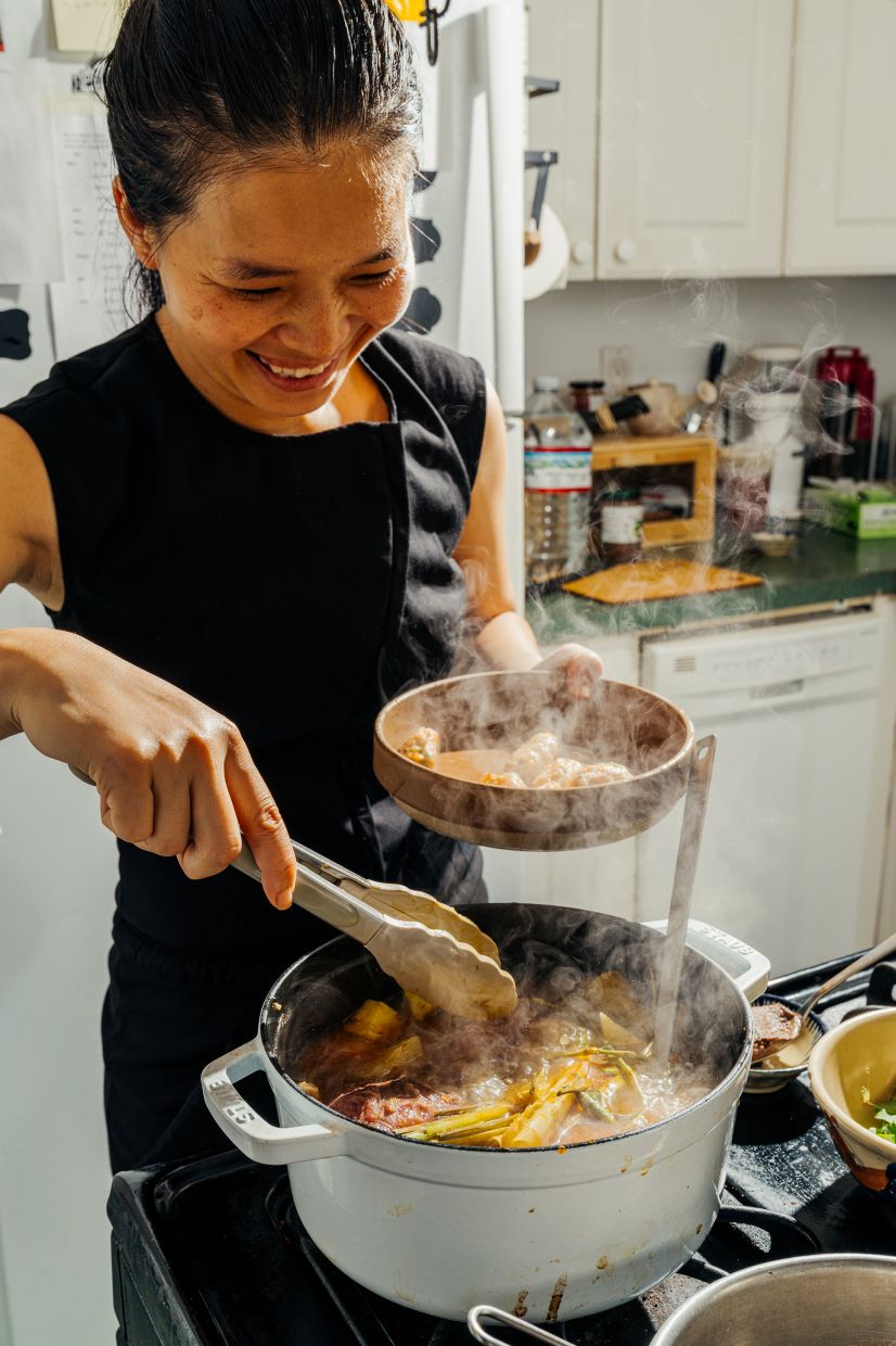 Nhu Ton, the chef of Bánh Vietnamese Shop House and Bánh Anh Em, prepares a bubbling pot of bún bò huế for herself at home in New York. — Photo: Janice Chung/The New York Times
