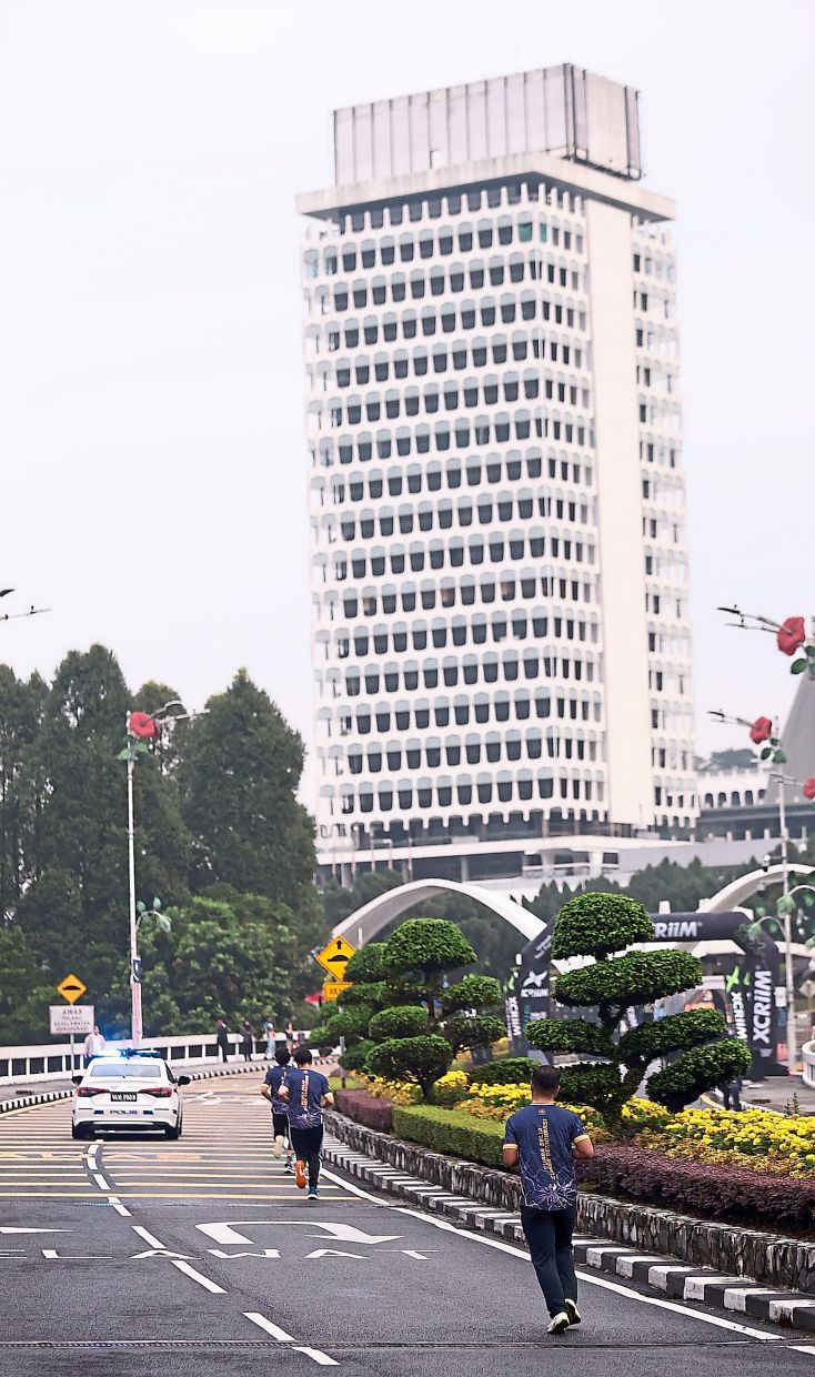 Runners making their way back to Parliament Building during the 5km run in Kuala Lumpur.