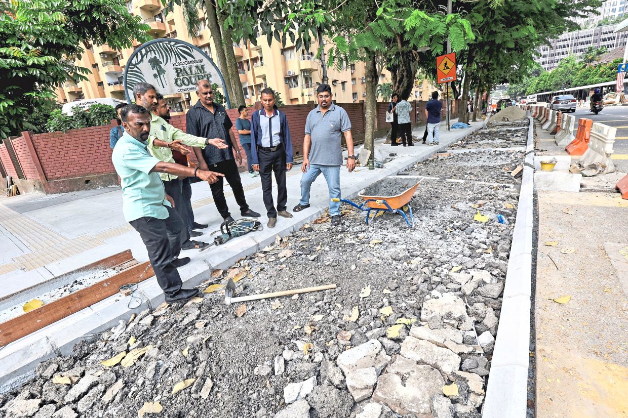 (From left) Rajasingam, Gopinathan and Naidu (right) with other stakeholders voicing their objections on construction of the bicycle lane.