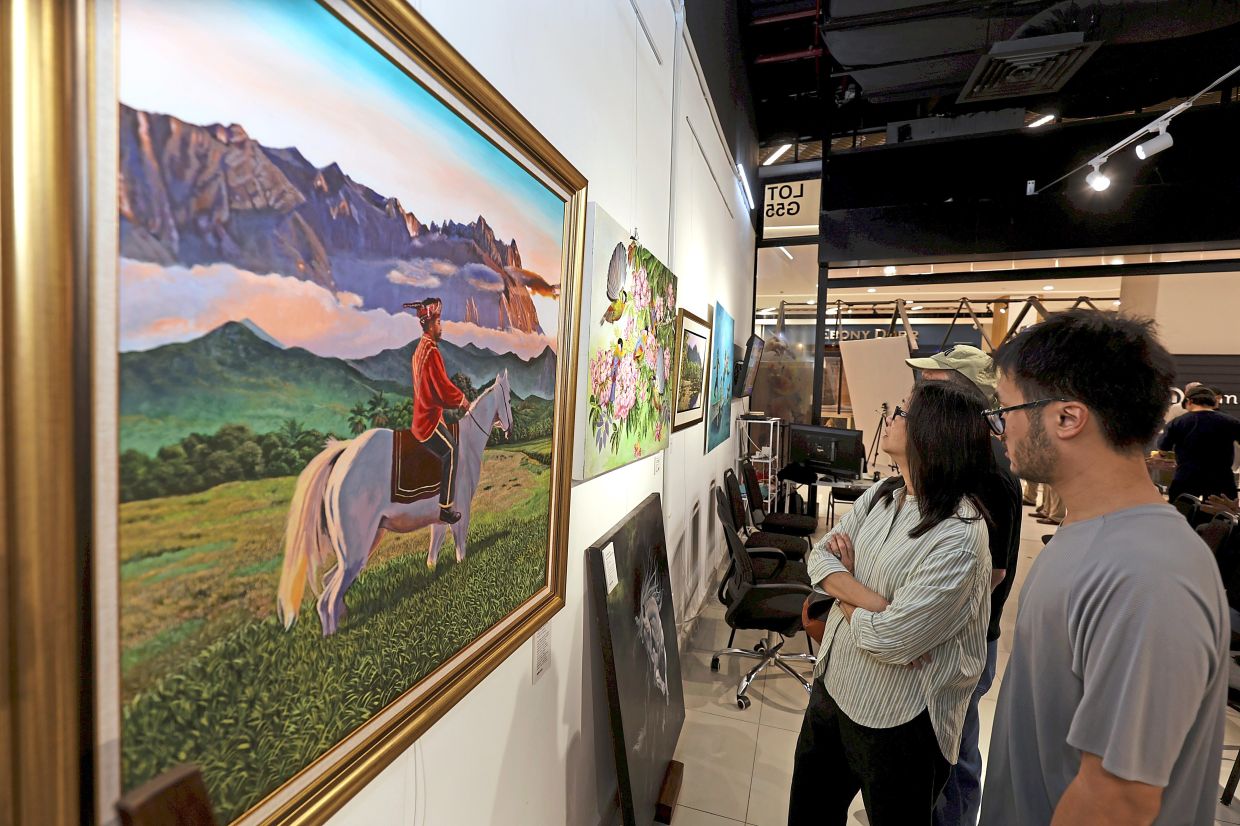 Visitors taking in Siva’s artwork titled ‘The Bajau Horseman’.