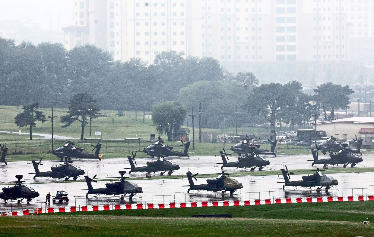 US Army AH-64 Apache helicopters are seen at Camp Humphreys in Pyeongtaek recently for the annual war games between South Korea and the US. — AFP