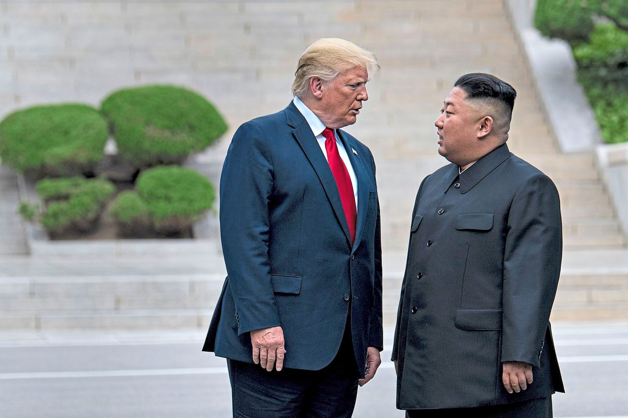 Trump and Kim walking through the Demilitarized Zone between the two Koreas during their last meeting in June, 2019. — Filepic/AFP