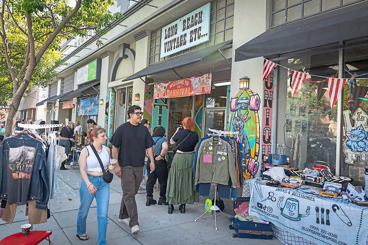 Vendors line the sidewalk for Likho's birthday party. The cat is a local celebrity.