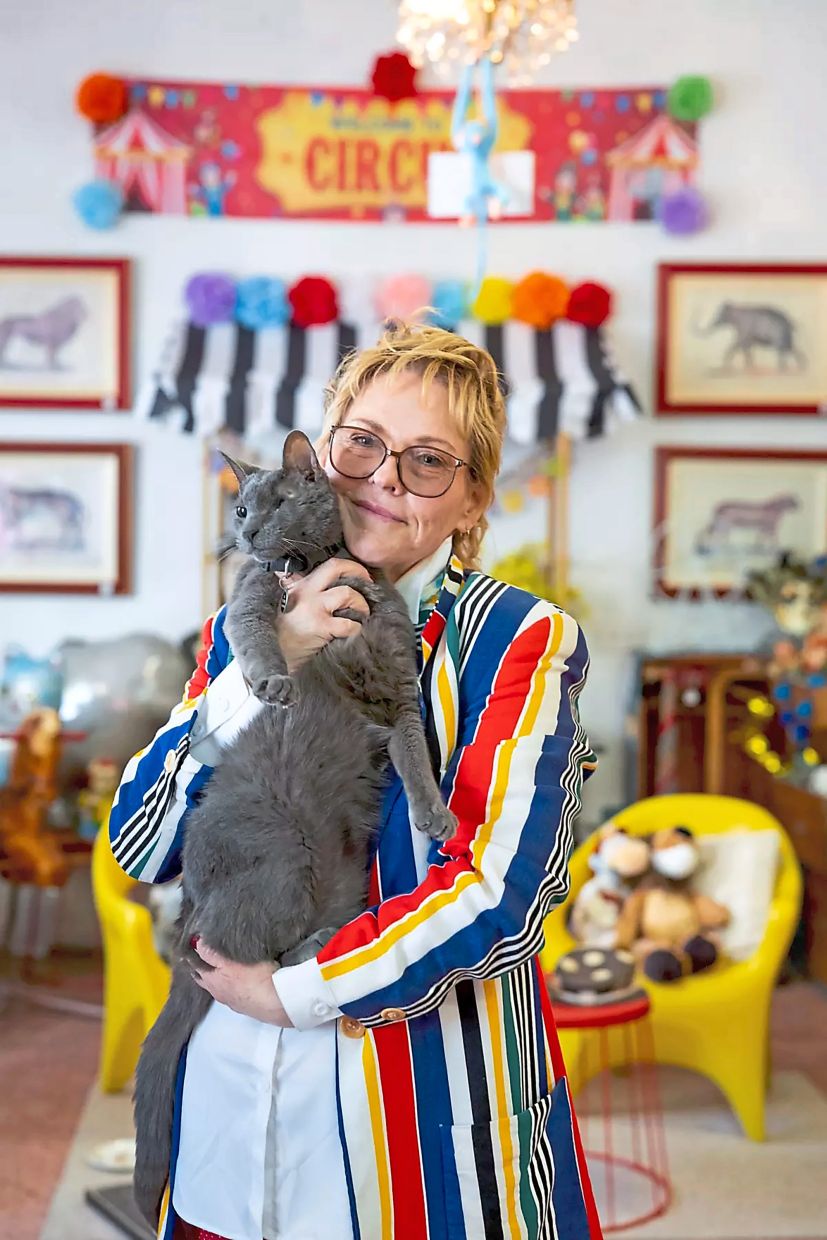Kobliha holds her cat Likho. When she opened her vintage store, she knew she wanted a shop cat just like chill bookstore cats.