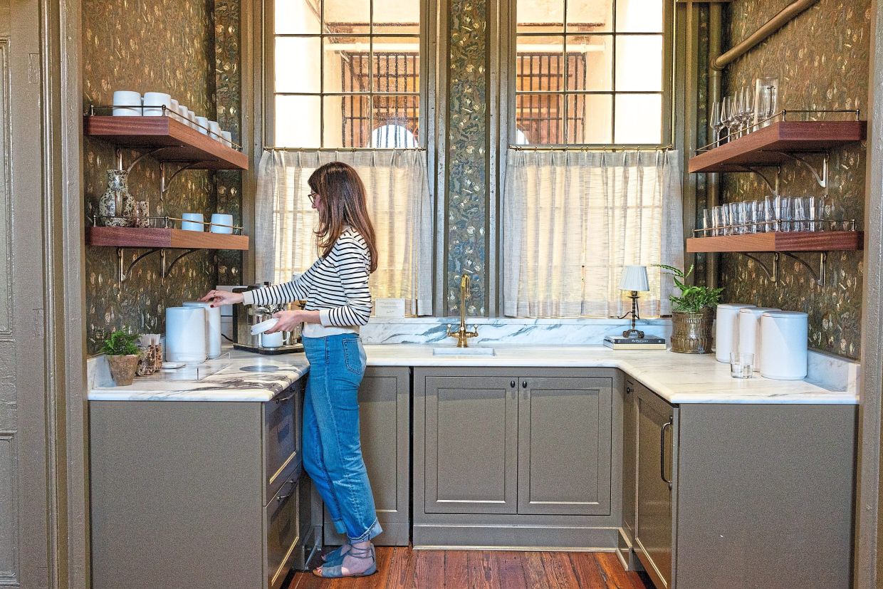 Emma Blackman, the magazine’s senior manager of events, gets a snack in the kitchenette area.