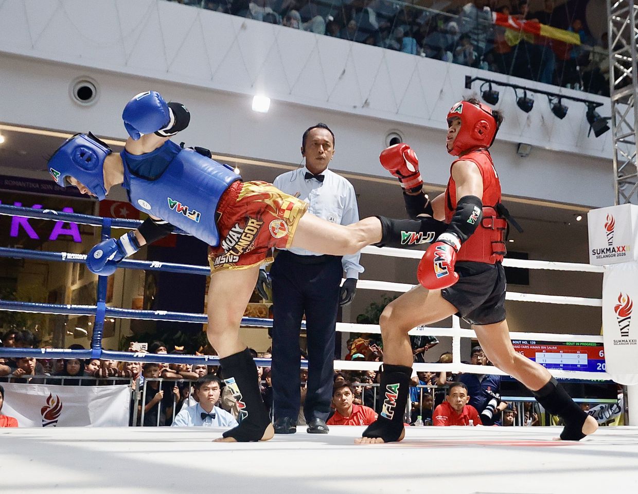 Selangor’s Arysh Shaddad Ubaidillah Nasri (blue) fight for the gold medal against Penang’s Mohd Faris Aiman Salimi in the men’s 60-63.5kg final during Malaysia Games (Sukma). — FAIHAN GHANI/The Star