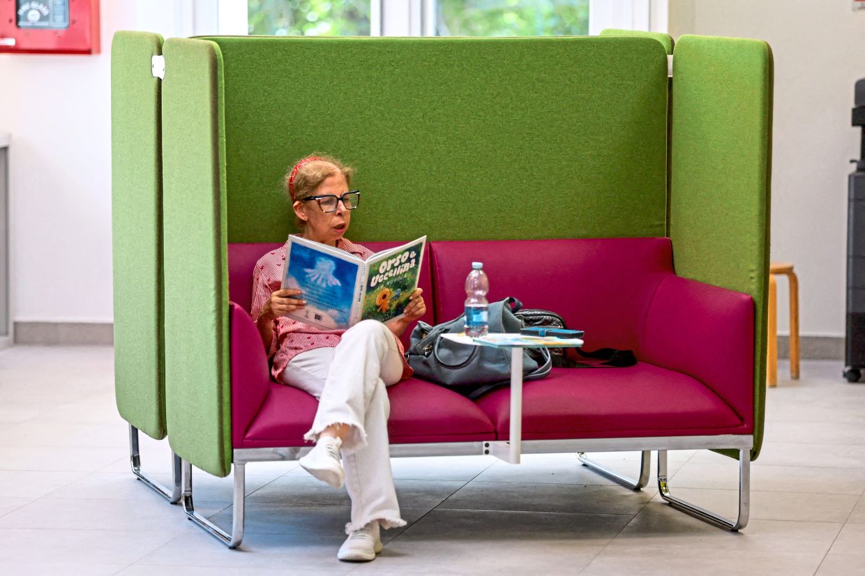 A woman reads inside Corviale’s renovated library.