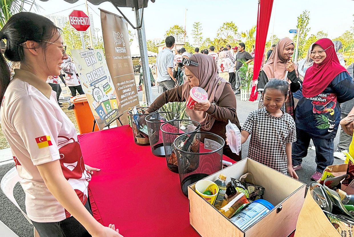 Visitors testing their knowledge on separating waste according to the correct categories.